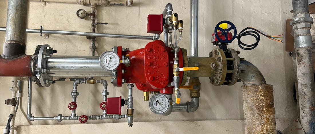 Valve sets and riser pipework in a commercial plant room installed by Sentry