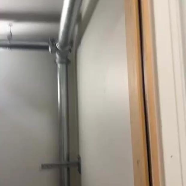 New galvanised dry riser pipework and a landing valve fitted beside a doorway