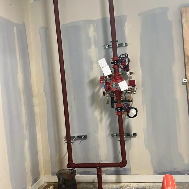 A new pre-action sprinkler valve set with its trim and gauges, installed to protect a comms room