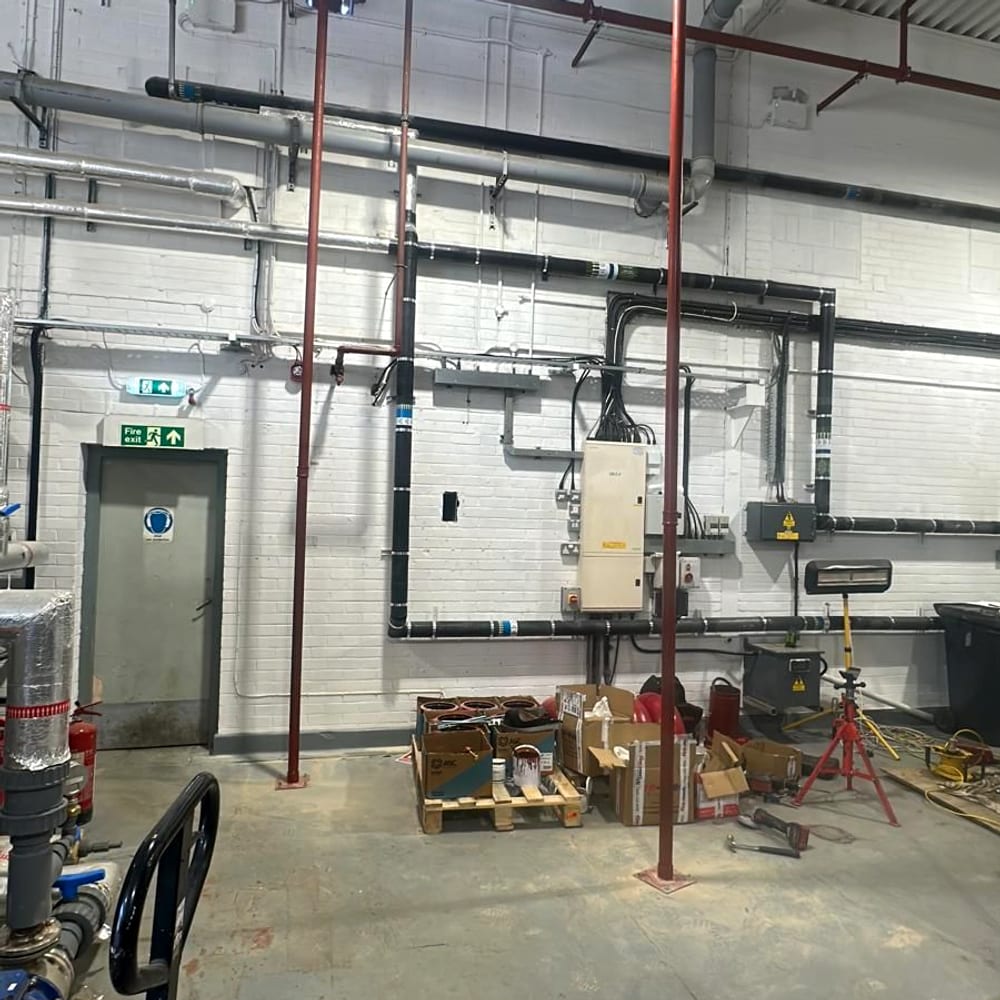 Riser pipework running through a plant room, the kind of installation sprinkler servicing for care homes covers