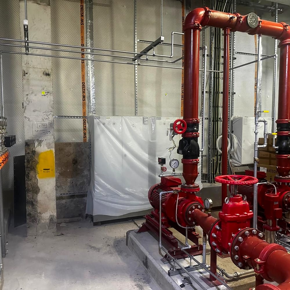 A sprinkler valve set and riser pipework in a plant room, the kind of installation sprinkler servicing for schools covers